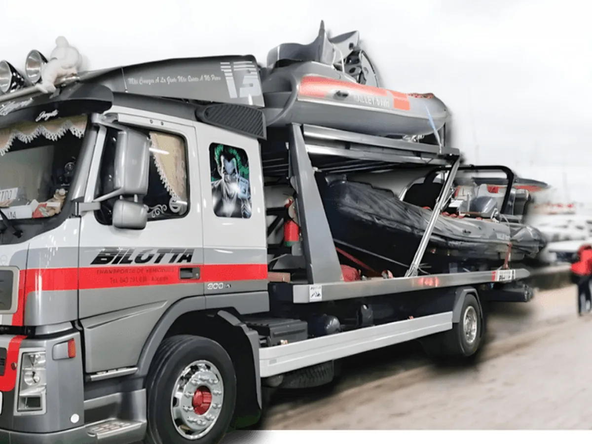 A boat being transported by road on a Bilotta truck